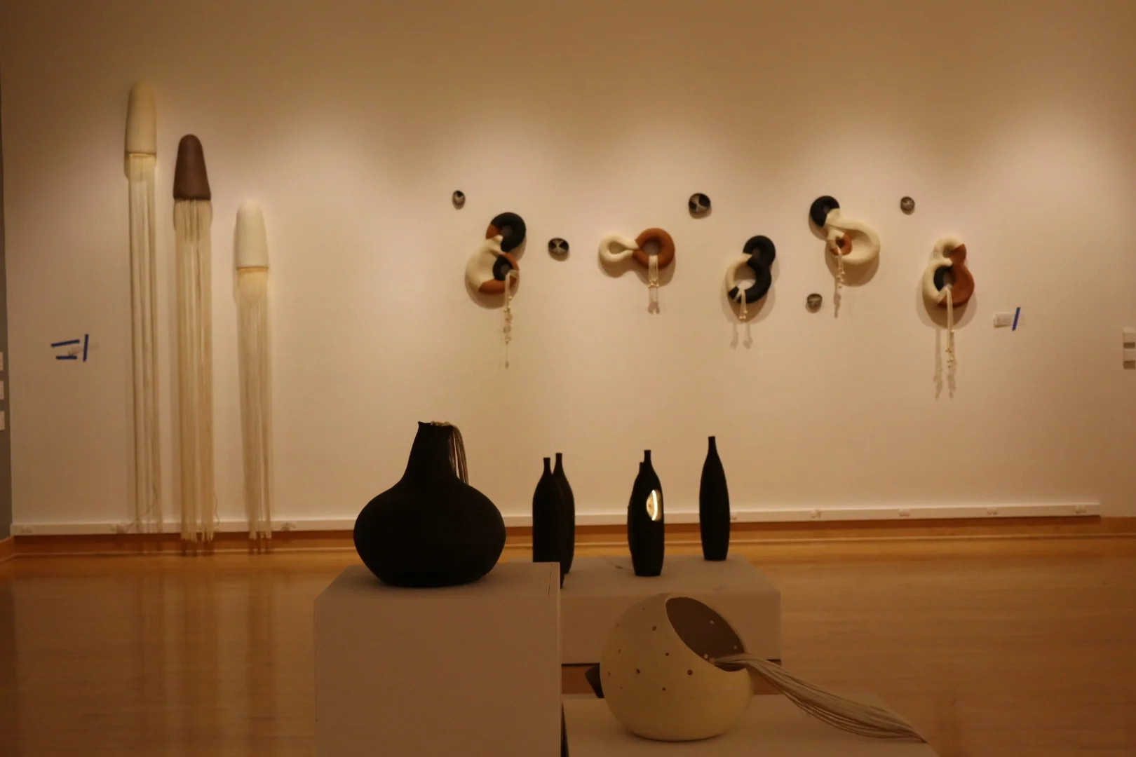 Tall brown ceramic floor lamp with a glowing central opening