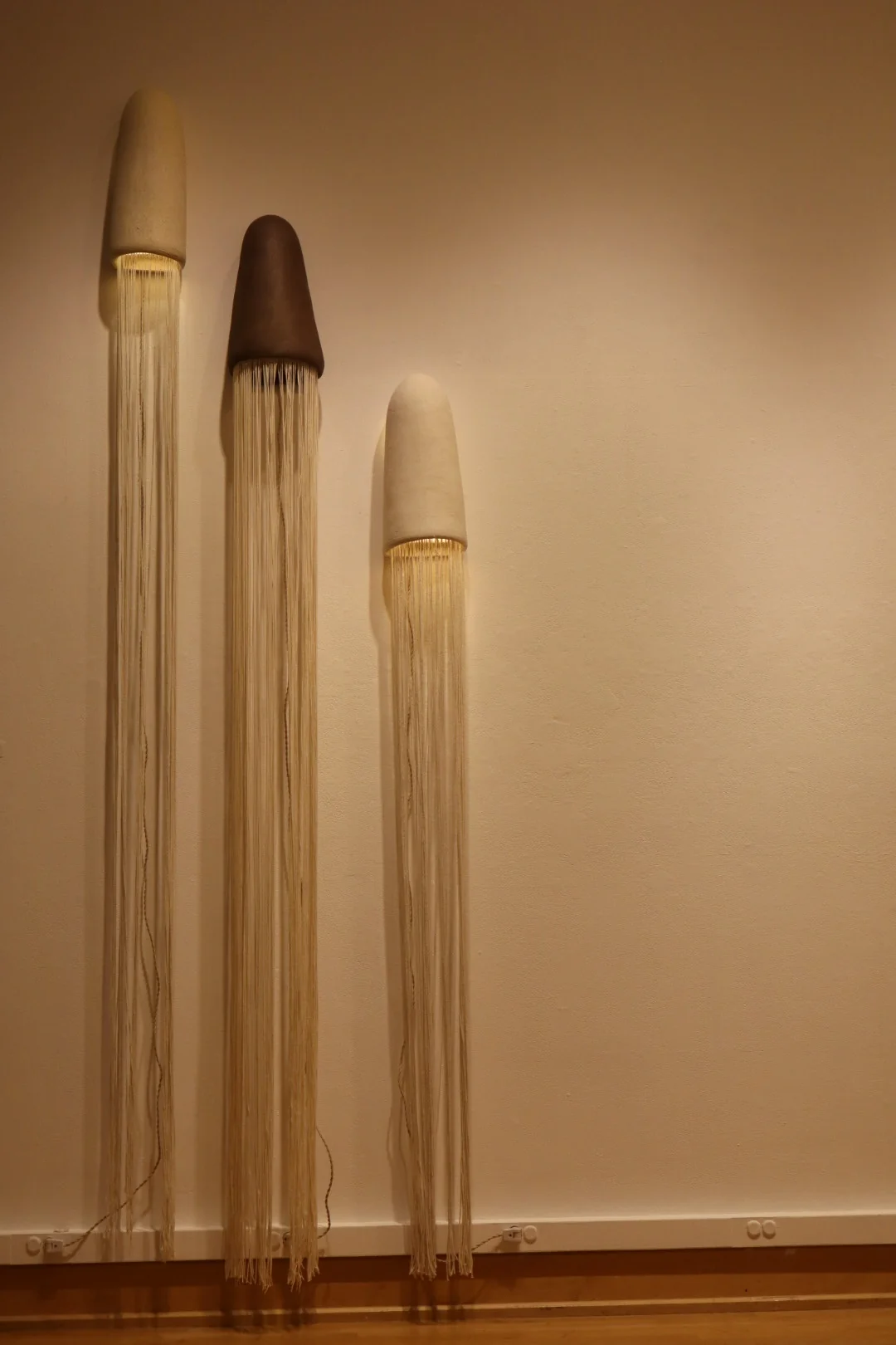 Four black hand-built ceramic vessels with horizontal ridges