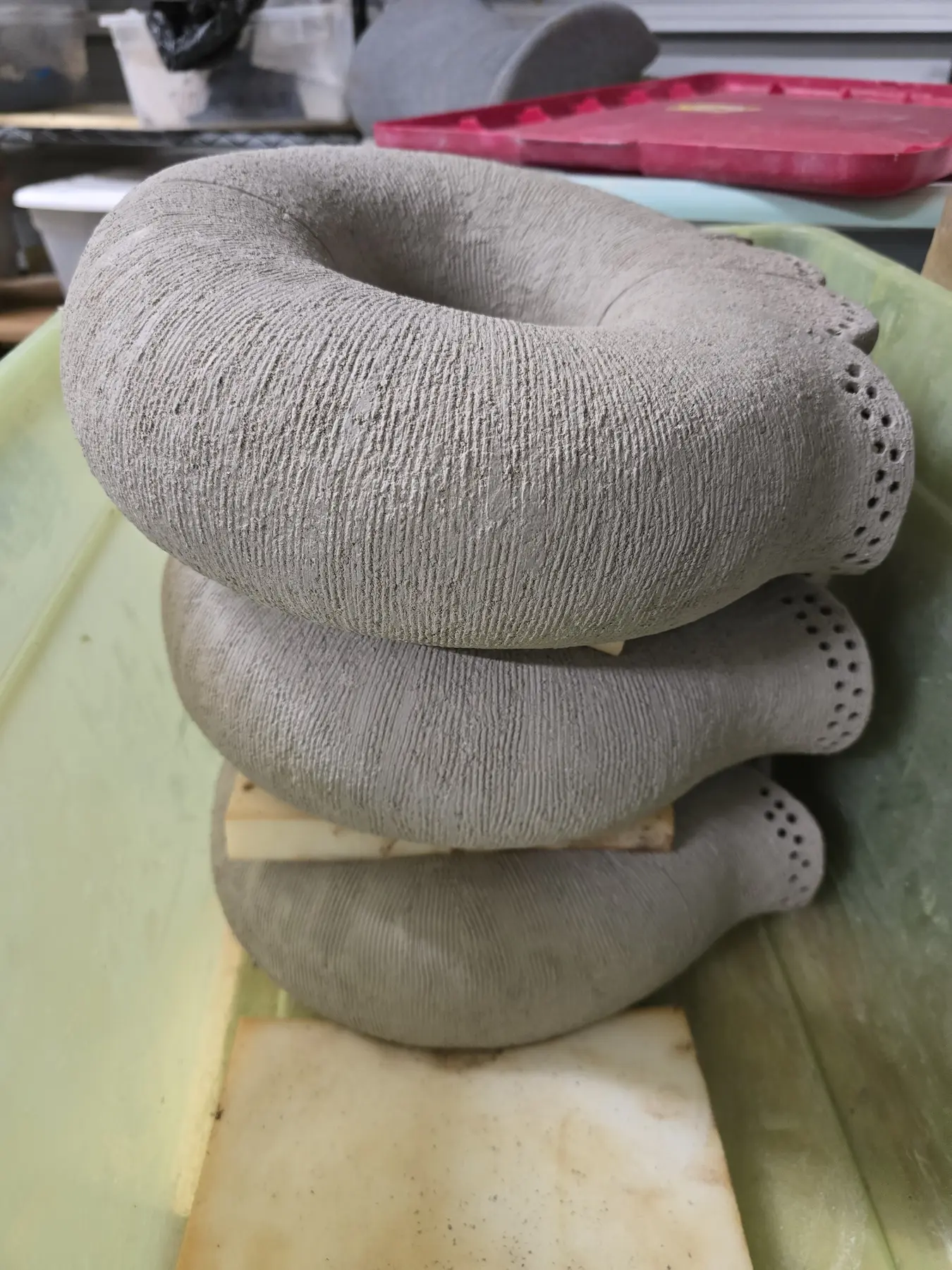 Stacked rounded clay forms with textured surfaces